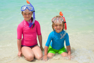 Happy children wearing snorkeling gear  on the beach