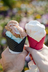 Male and female hand toast with ice cream cone