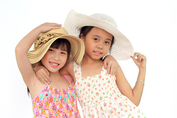 Two beautiful happy little asian girl with straw