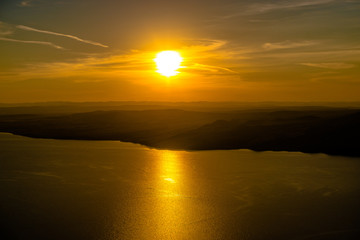 Beautiful landscape with hills and wide river at sunset 