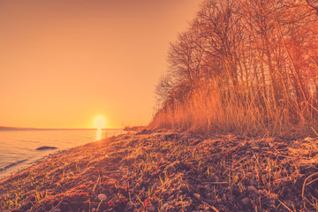 Wall Mural - morning sunrise by a large lake