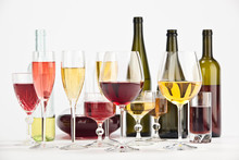 Elegant Glasses Of White Red Wine Composition Isolated On White