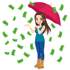 Beautiful brunette woman holding big umbrella happy seeing raining money bills