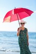 © WavebreakmediaMicro - Senior woman posing with an umbrella