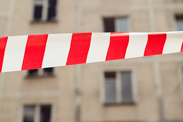 Red and white ribbon prohibiting the passage to the house to be demolished