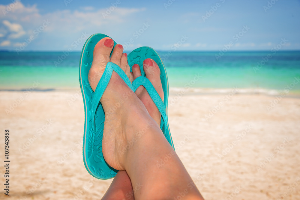 Selfie photo of woman feet with blue flip flops, relaxing on a tropical ...