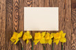Fresh  spring yellow  daffodils  flowers and empty tag on brown painted wooden planks. Selective focus. Place for text.