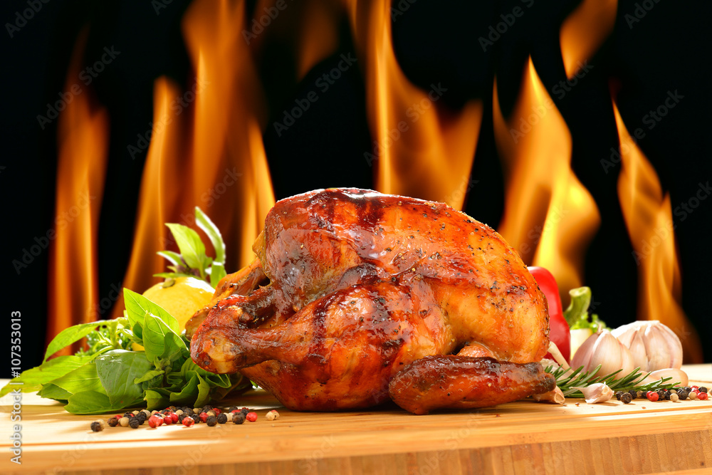 Roast chicken and various vegetables on a chopping wood - obrazy, fototapety, plakaty 