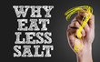 Hand writing the text: Why Eat Less Salt?