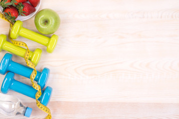 Wall Mural - Fitness equipment on wooden background with copy space