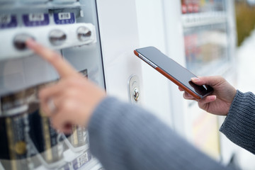 Poster - Woman using cellphone to pay the vending machine