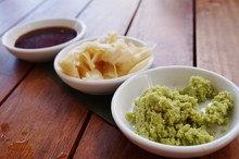 Dishes Of Green Wasabi, Pickled Ginger And Soy Sauce Japanese Condiments