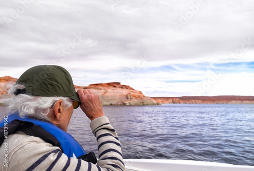 Fotografie, Obraz Active senior out on a boat wears a hearing aid