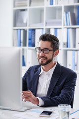 Portrait of smiling young entrepreneur enjoying his work