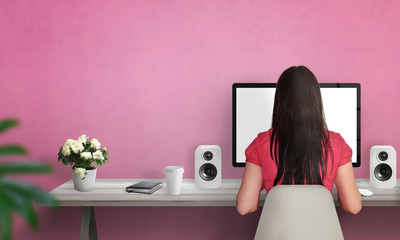 Aufkleber - Woman work on computer. Flowers, notebook, speakers, on table. Free space on wall for text. Pink wall in background.