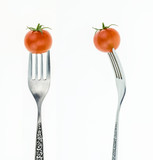Fototapeta Kuchnia - Cherry tomato on fork, front and side view, on white background.