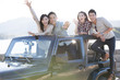 © Blue Jean Images - Friends having fun in a jeep