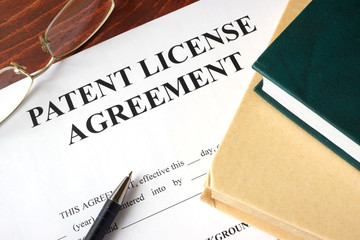 Patent License agreement on a table. Copyright concept.