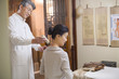 © Blue Jean Images - Senior Chinese doctor giving moxibustion