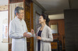 © Blue Jean Images - Senior Chinese doctor talking with patient