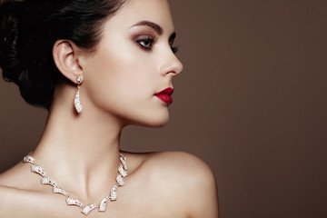 Wall Mural - fashion portrait of young beautiful woman with jewelry. brunette girl. perfect make-up. beauty style