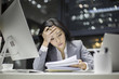 © Blue Jean Images - Businesswoman working late in office