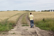© snaphappy28 - young boy walking down a trail through a wheat field