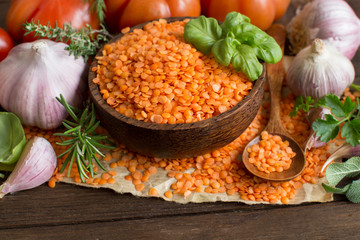 Red lentils in a bowl with vegetables and herbs