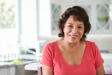 Head And Shoulders Portrait Of Senior Hispanic Woman At Home