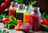 Four kind of vegetable juices: red, burgundy, orange, green, in