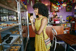 © Peathegee Inc/Blend Images - Mixed race woman buying pastries in bakery