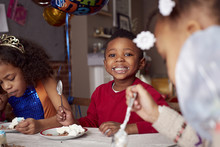 Children Eating Cake At Party