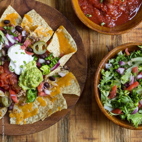 Vászonkép Nacho Cheese Tortilla chips with chili and salsa