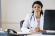 © JGI/Jamie Grill/Blend Images - Mixed race doctor sitting at desk in office