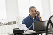 © JGI/Tom Grill/Blend Images - Black businessman talking on telephone in office