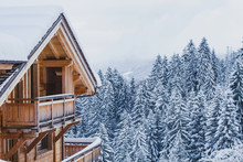 Winter Holidays, Ski Vacations Background, Wooden House Under Snow In The Alps