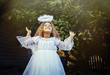 © Inti St Clair/Blend Images - Mixed race girl wearing angel costume in backyard