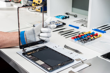 Wall Mural - Close-up photos showing process of tablet device repair