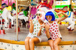 © Nabokov Alex - Two beautiful girls in bright colored wigs to cocktails in hand having fun at amusement park