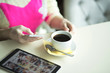 © byswat - Female hand on the table, technology, internet, woman drinking coffee