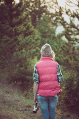 Wall Mural - Woman posing outdoor. Hiker  enjoying view in forest during hiking trip.