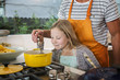 © Sam Diephuis/Blend Images - Father and daughter cooking in kitchen
