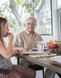 © Sam Diephuis/Blend Images - Caucasian multi-generation family eating at table