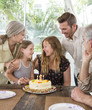 © Sam Diephuis/Blend Images - Caucasian family celebrating birthday at table