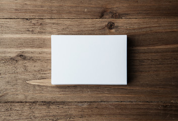 Photo of blank white identity stack. Empty business cards on wood table background, ready for your private information. Horizontal mockup    