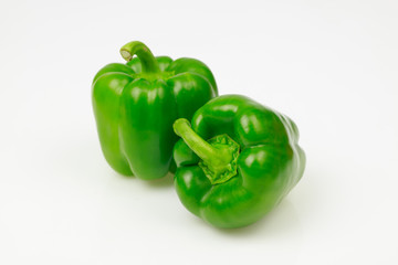 Wall Mural - Two green bell peppers, on white background.