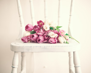 Wall Mural - Pink and white tulips in a vintage white wood chair