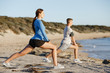 © Sergey Nivens - Young couple on beach training together