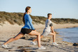 © Sergey Nivens - Young couple on beach training together