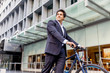 © Sergey Nivens - Successful businessman riding bicycle
